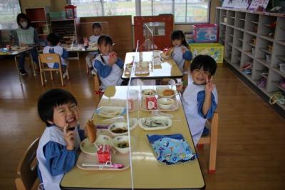 4人が給食を食べている写真