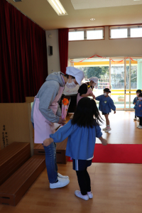 配膳員さんにお礼のお花を渡している写真